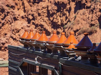 group of tajines on charcoal used to prepare dishes at a restaurant near the Ouzoud waterfalls in Morocco's Atlas Mountains; Ouzoud, Morocco